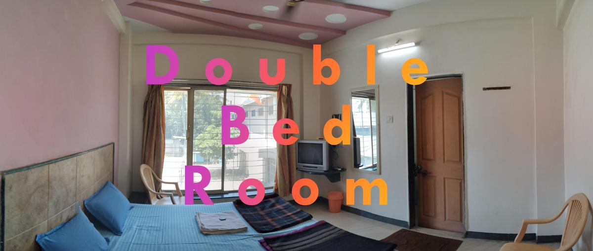 Double bed room at Hotel Swaraj Delux Shirdi - budget hotel near Sai Baba Temple